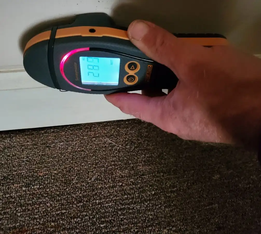 Moisture detection at baseboard during Storm Damage Restoration in Fairmont